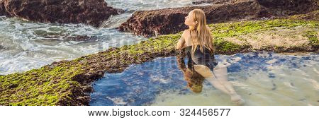 Young Woman Tourist On Pantai Tegal Wangi Beach Sitting In A Bath Of Sea Water, Bali Island, Indones