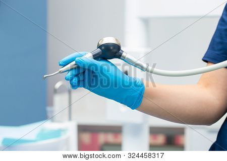 Close-up Teeth Airflow Tool In The Hand.