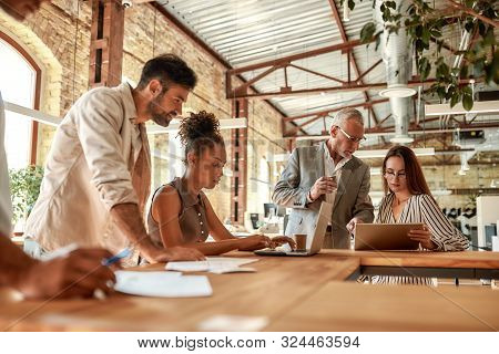 Office Life. Group Of Business People Working Together And Communicating In The Modern Office