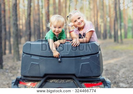 Cute Adorable Caucasian Blond Siblings Having Fun During Atv 4x4 Off-road Adventure Trip Amog Conife