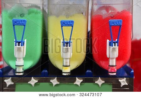 Three Dispenser Of Shave Ice With Syrup Called Grattachecca Or Granatina In Italian Language