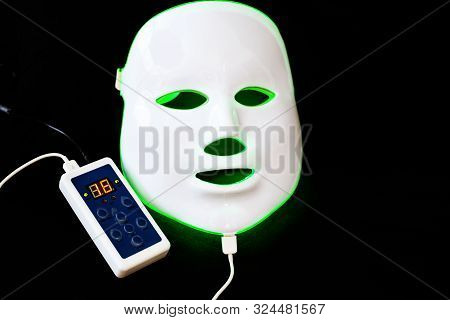 Light Rejuvenating Mask For Facial Skin Therapy On Black Background
