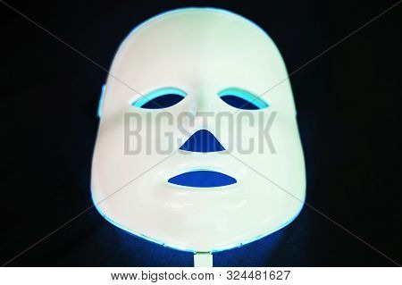 Light Rejuvenating Mask For Facial Skin Therapy On Black Background
