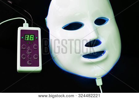 Light Rejuvenating Mask For Facial Skin Therapy On Black Background