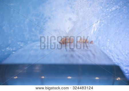 4 Years Boy Playing With Jets At Indoor Pool Spa. Selective Focus