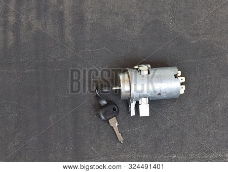 Car Ignition Lock With Keys On A Black Background.
