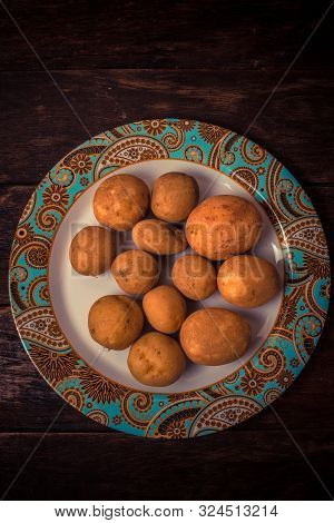 Fresh And Raw Potatoes Stacked In A Round Dish On Wooden Table. Rustic Style..