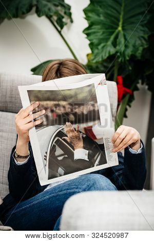 Paris, France - Sep 27, 2019: Woman Reading Liberation Portrait In Living Room Newspaper Following T