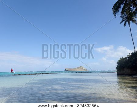Pahonu Pond (ancient Hawaiian Fishpond) With Shallow Wavy Ocean Waters With Rabbit Island And Rock I