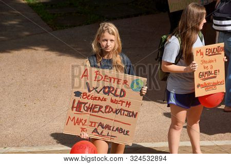 Honolulu - November 12, 2015:  Lady Holds Sign Saying A Better World Begins With Higher Education Ma
