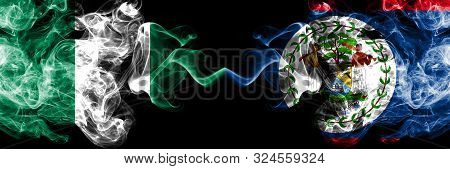 Nigeria Vs Belize, Belizean Abstract Smoky Mystic Flags Placed Side By Side. Thick Colored Silky Smo