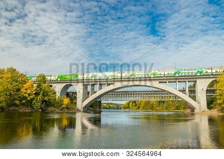 Kouvola, Finland - 25 September, 2019: Autumn Landscape Of Bridge With Moving Passenger Train And Ky