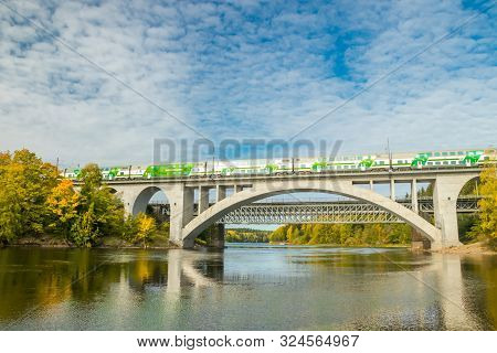 Kouvola, Finland - 25 September, 2019: Autumn Landscape Of Bridge With Moving Passenger Train And Ky
