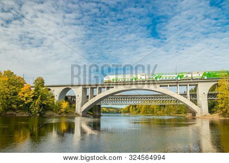 Kouvola, Finland - 25 September, 2019: Autumn Landscape Of Bridge With Moving Passenger Train And Ky