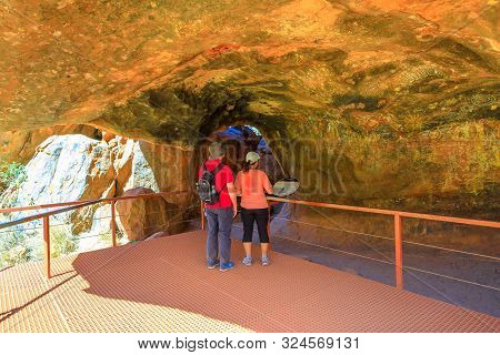 Uluru, Northern Territory, Australia - Aug 24, 2019: Couple Looking Aboriginal Art Inside Mutitjulu 