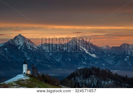 Panoramic View At St. Primus And Felician Church In Jamnik, Julian Alps, Slovenia