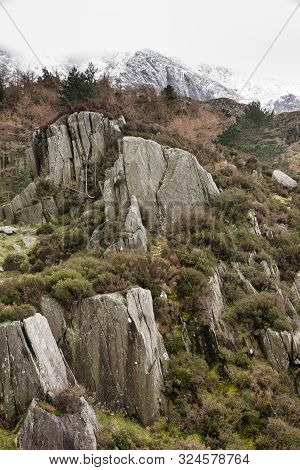 Stunning Dramatic Landscape Images Of Ogwen Valley In Snowdonia During Winter With Snowcapped Glyers