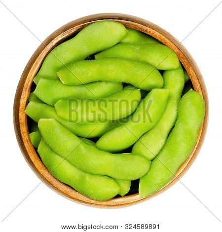 Edamame, Green Soybeans In The Pod, In Wooden Bowl. Unripe Soya Beans, Also Maodou. Glycine Max, A L