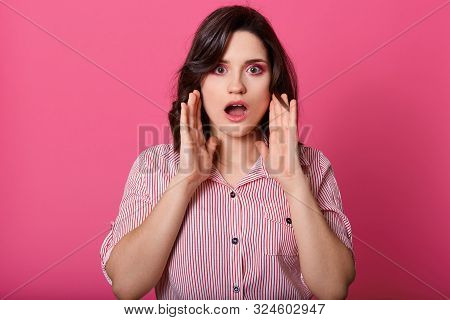 Close Up Portrait Of Shocked Girl With Her Mouth Opened, Keeps Near Face, Modelposing Isolated Over 