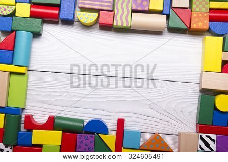 Colorful Kids Toys Frame On Wooden Background. Top View. Flat Lay. Copy Space For Text.
