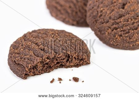 Dilicious Chocolate Rounded Cookies On White Plate With Bite Marks