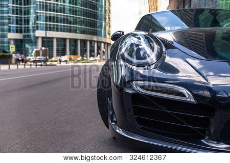 Russia Moscow 2019-06-17 Closeup Headlights Of New Shiny Luxury Dark Blue Sports Car Porsche 911 Par