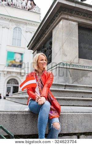 A Young Woman In A Red Jacket Sits On A Monument To Kaisers Von Joseph Ii In Front Of The National L