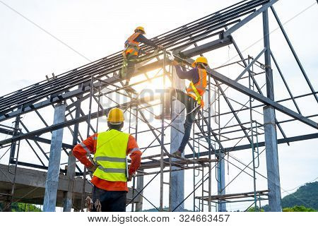 Engineer Technician Watching Team Of Workers On High Steel Platform,engineer Technician Looking Up A