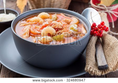 Soup With Turkey, Pasta, Carrot, Celery, Tomato And Cannellini Beans, Garnished With Parmesan Cheese