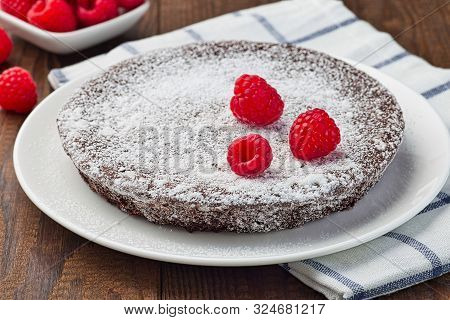 Chocolate Sticky Brownie Cake, Swedish Dessert Kladdkaka, On The Plate, Garnished With Icing Sugar A