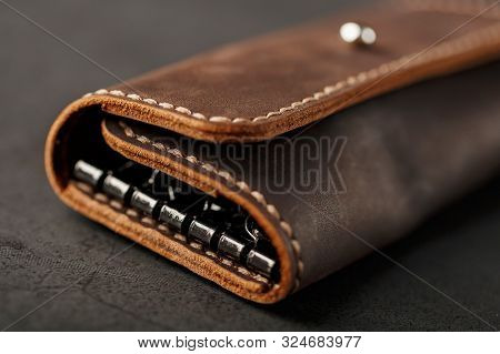 Wallet Keymaster Made Of Brown Genuine Leather, Handmade On A Dark Background
