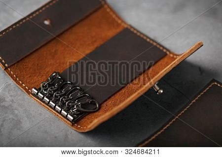 Wallet Keymaster Made Of Brown Genuine Leather, Handmade On A Dark Background