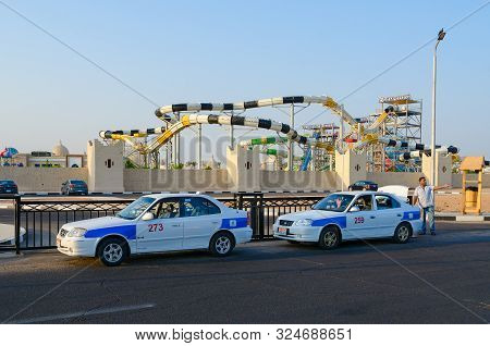 Sharm El Sheikh, Egypt - September 19, 2019: Unknown Man-taxi Driver Stands Near Taxi On Street At P