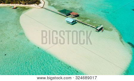Tropical Island Among Coral Reefs With A White Beach And Blue Atoll Water. Onok Island, Balabac, Phi