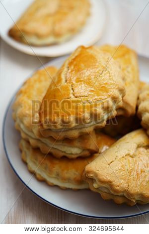 Freshly Baked Sochni Served On White Porcelain Plates. White Wooden Background, High Resolution