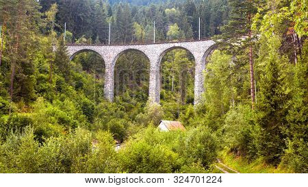 Landscape With High Bridge And Small House, Filisur, Switzerland. Panorama Of Alpine Forest. Scenic 