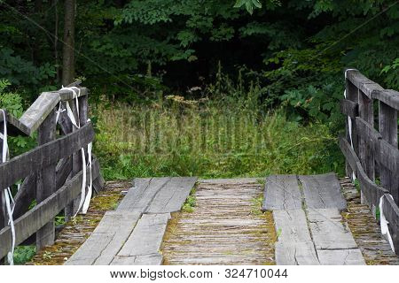 Wooden Road Or Bridge With Old Railings Across The River. Bottom View, Copyspace