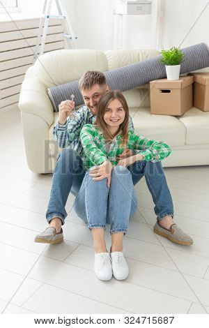 Young Married Couple With Boxes And Holding Flat Keys.