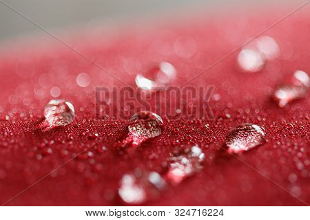 Water Droplets On  A  Jacket Of Red Waterproof Fabric