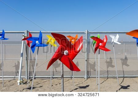 Colorful Windmill Toy Standing On Iho Tewoo Beach, Jeju Island, South Korea