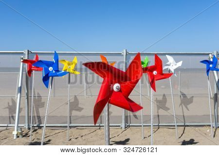 Colorful Windmill Toy Standing On Iho Tewoo Beach, Jeju Island, South Korea
