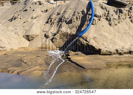 Blue Pipe With Water Poured Into The Sea, Iho Tewoo Beach, Jeju Island, South Korea
