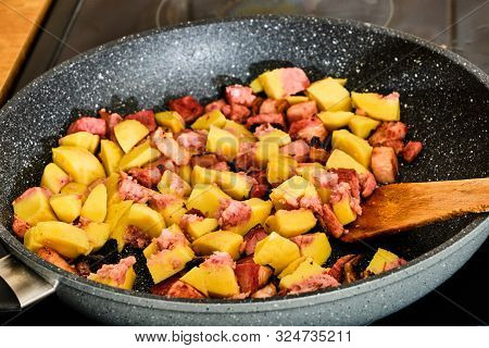 Cooking Tasty Pork Smoked Bacon Meat With Potato Dumpling Pieces With Smoked Meat On Hot Frying Pan 