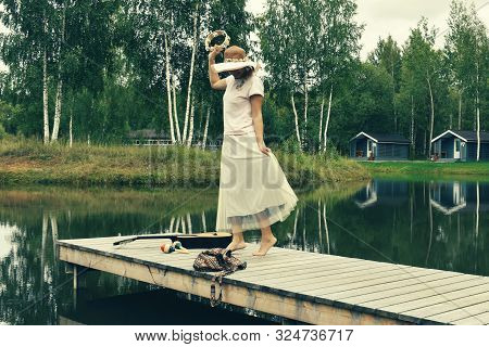 Woman In A Dress With A Tambourine. Shamanistic Dances In Nature. Summer Fun Vacation On The Lake.