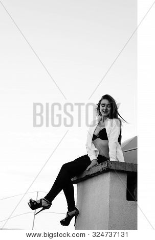 Young Sexy Woman Posing In The Roof, Wearing Leater Jacket, Swag Floral Hat Mirrored Sunglasses And 