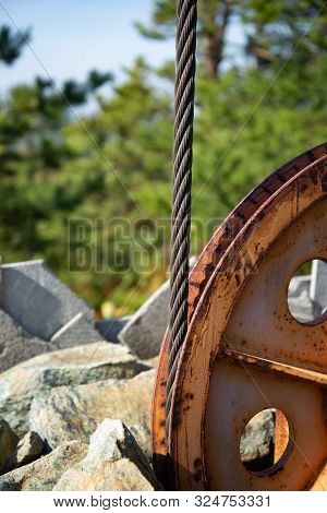 Steel Cable And Winch. Part Of An Old Winch With A Steel Rope On A Lift. Detail Of The Cableway. Clo