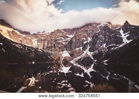 Spectacular View To The Beautiful Mountains With Mirroed Reflection And Clouds At Sunrise Time.