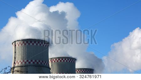 White Smoke Comes From Pipes Against Blue Sky. Problem Harmful Emissions And Air Pollution Of Centra