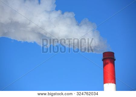 White Smoke Comes From Pipes Against Blue Sky. Problem Harmful Emissions And Air Pollution Of Centra