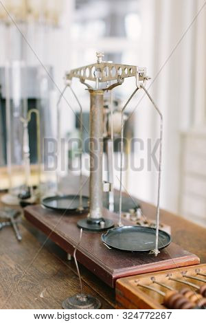 Vintage Pharmaceutical Scales On An Old Wooden Table With Other Pharmaceutical Supplies